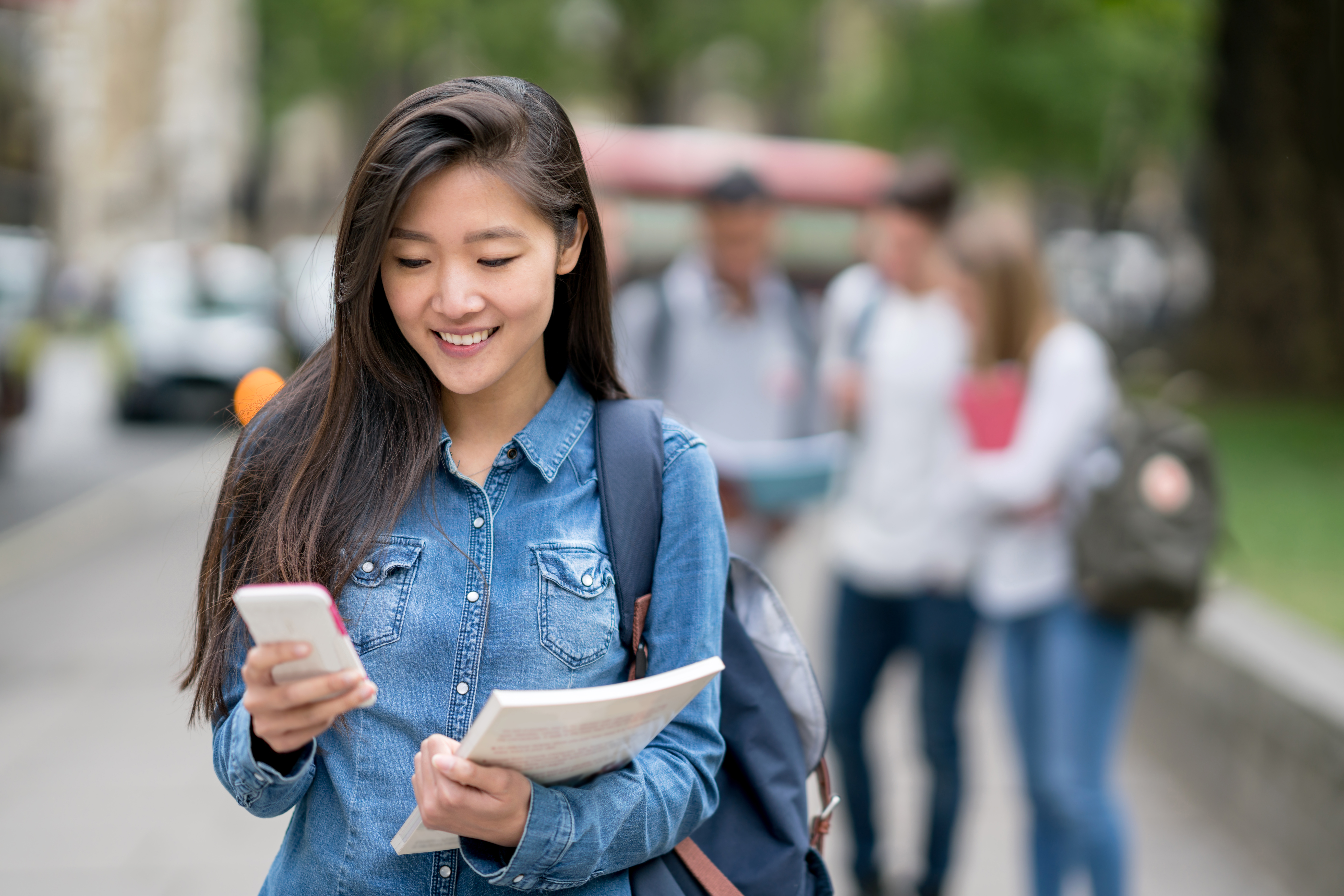 Woman walking while looking at her phone