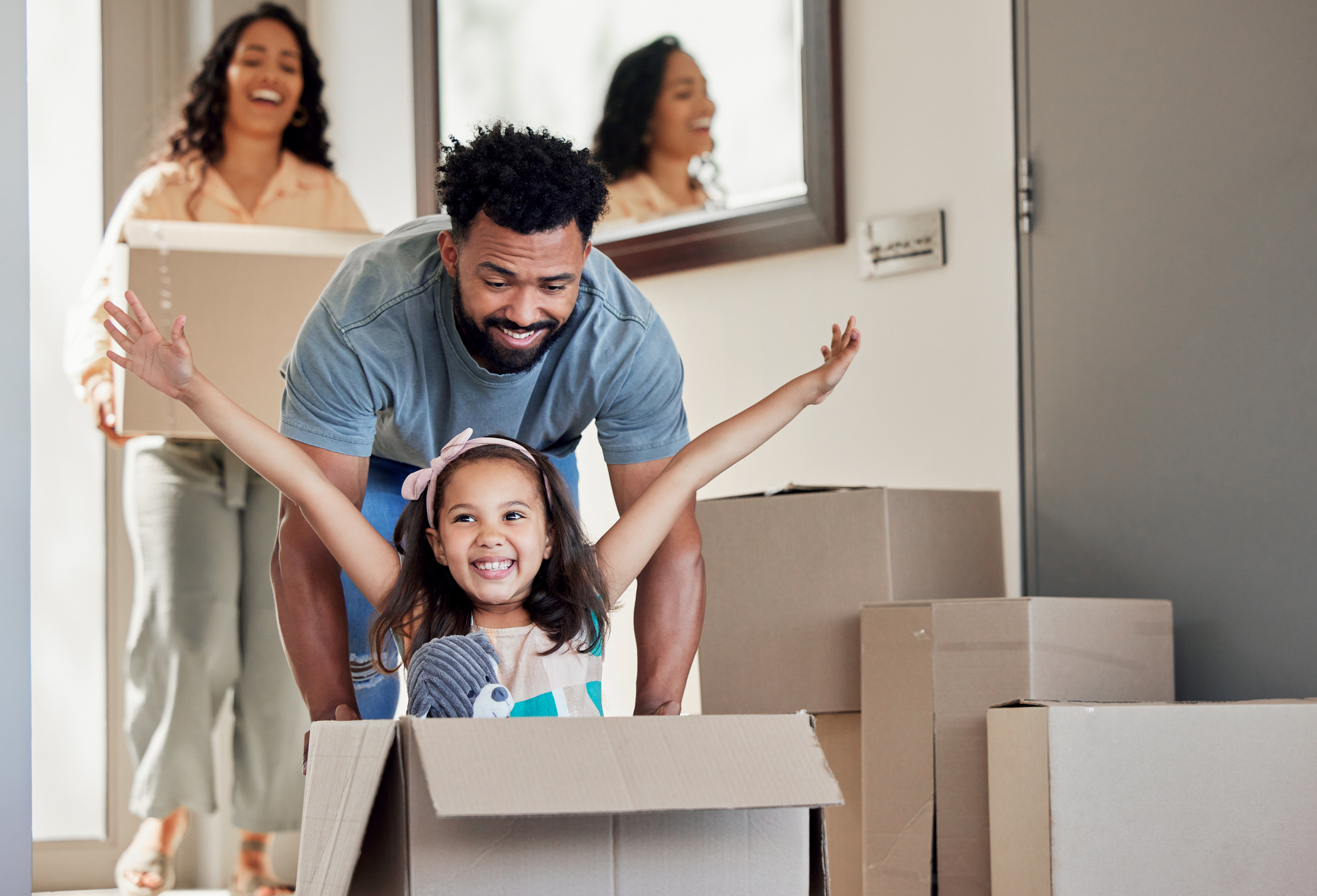 moving budget. Shot of a young father having fun with his daughter at home