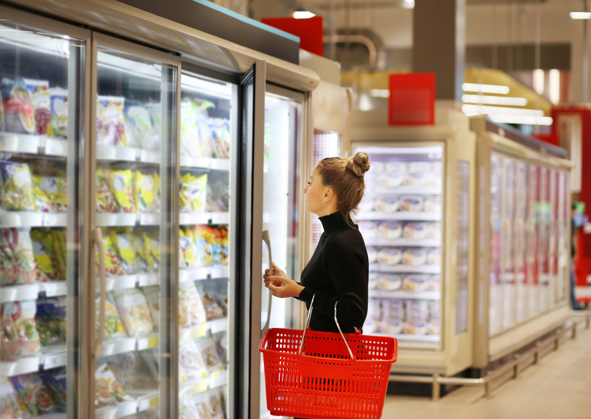 Woman choosing frozen meals