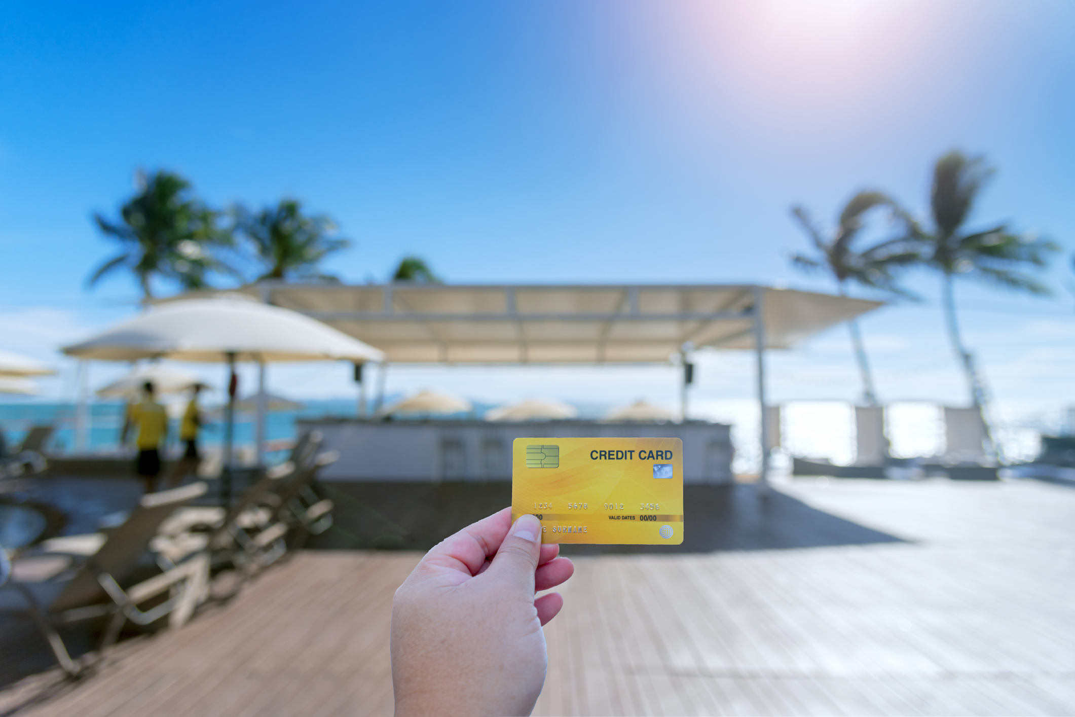 Photo of rewards credit card with pool background.