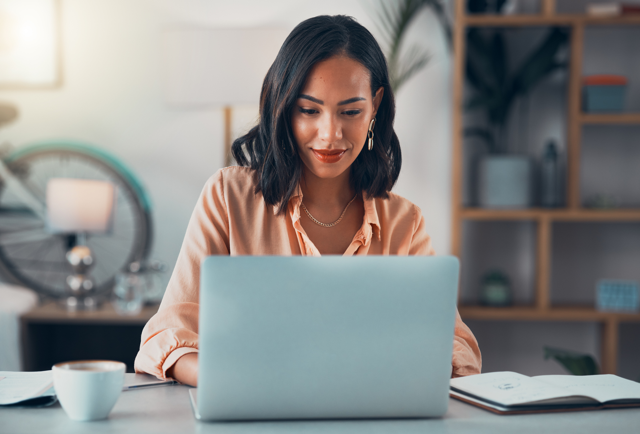 woman at computer, searching for unclaimed property.