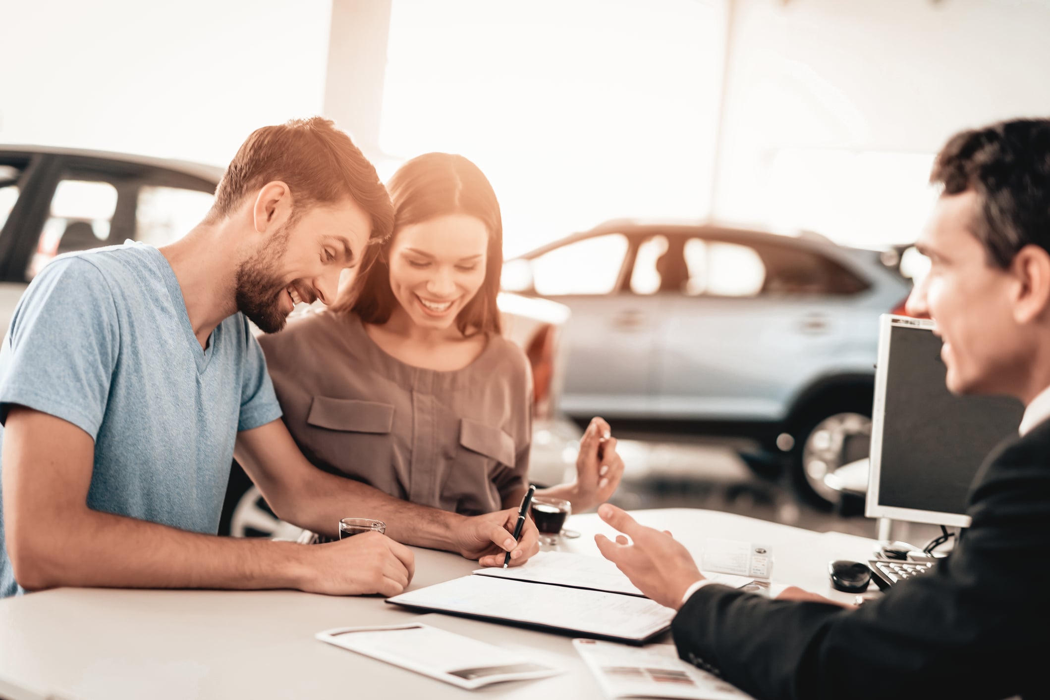what credit score do you need to buy a car? Happy Young Family Are Signing A Contract To Buy A Car. Dialogue With Dealer. Cheerful Customer. Automobile Salon. Make A Decision. Cup Of Coffee. End Of A Deal. Good Offer. Buyer And Seller.