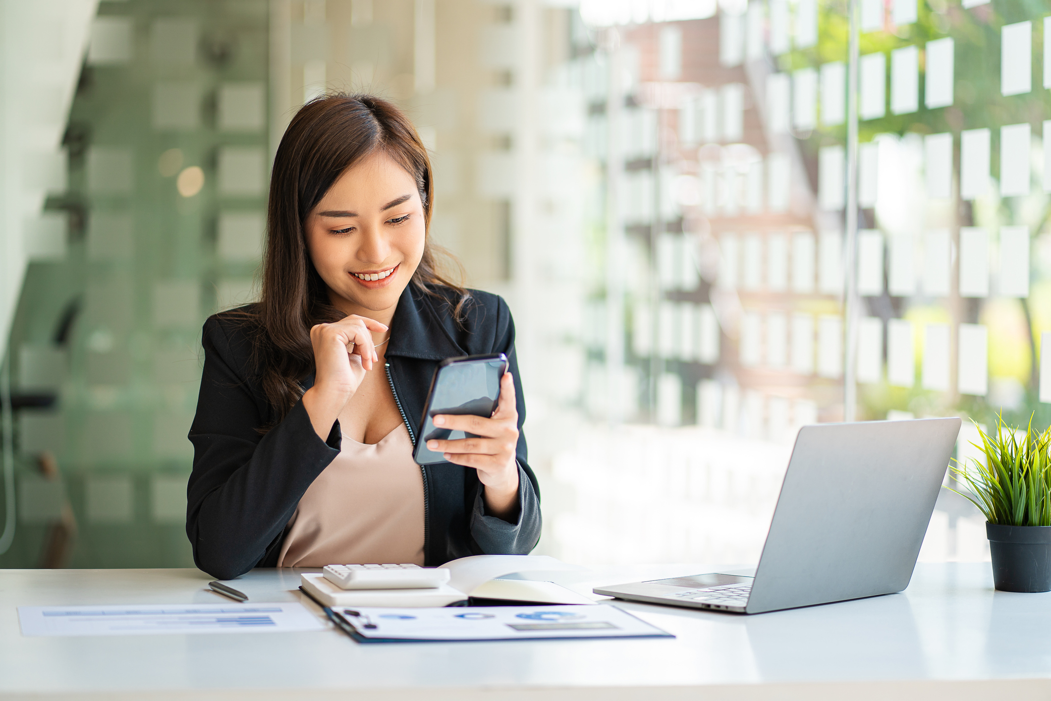 borrow money app. Asian business woman working in finance with laptop and smartphone, accounting concept.