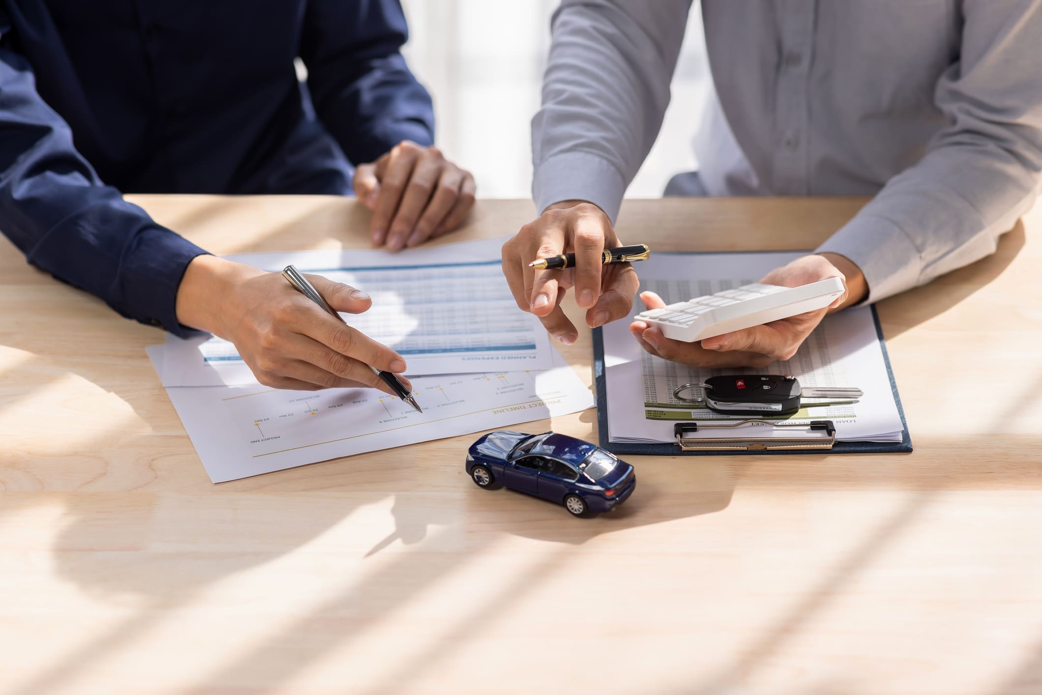 lease a car with bad credit. Dealer salesman giving car key to owner. client signing insurance document or rental car lease form agreement contract Insurance car concept.