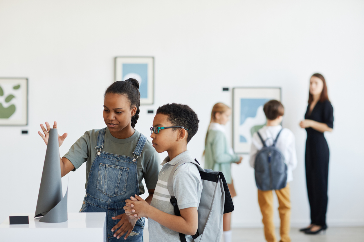 indoor activities. Kids in a museum looking at art.