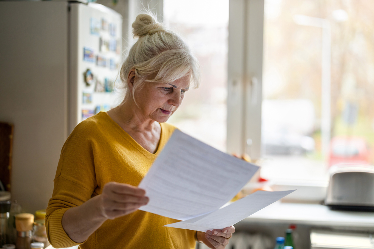 get your affairs in order. Senior woman filling out financial statements