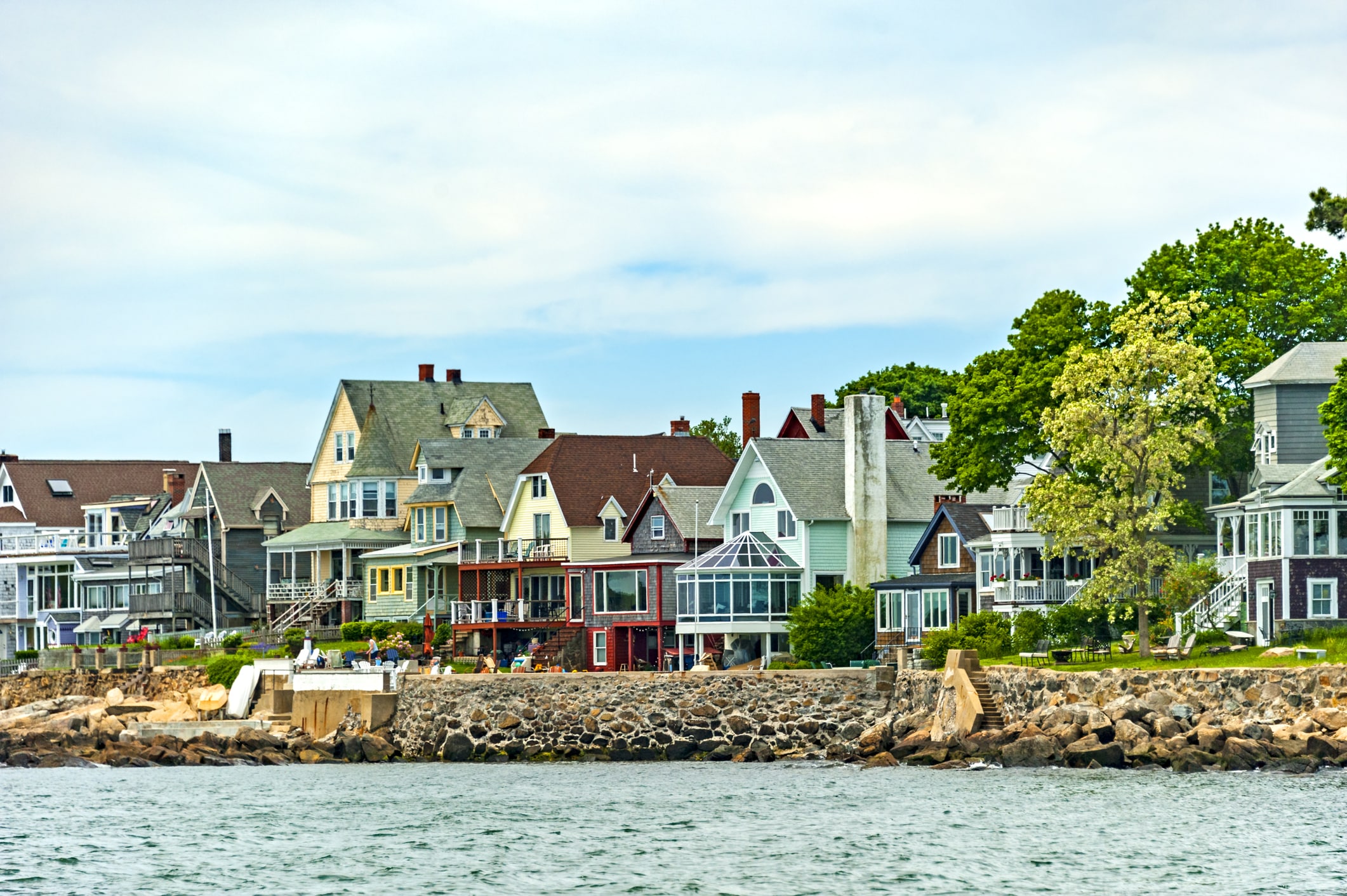 local trips: salem MA. rocky shoreline with brightly colored beach houses.